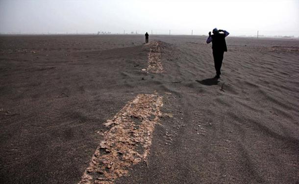 Archaeologists are examining a possible historic site in an arid area of Iran that was exposed by sandstorms in late March. The team is doing surveys, excavating structures and examining earthenware vessels.