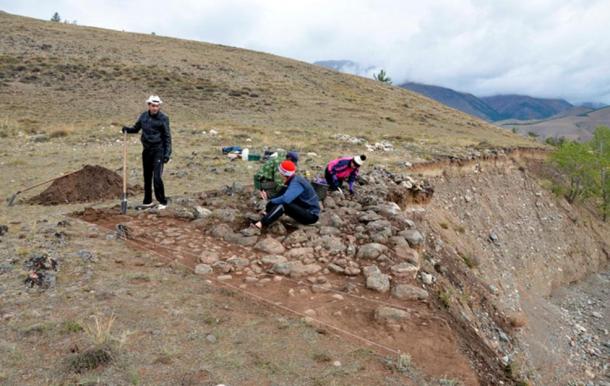 Archaeologists excavating the site where the infant’s remains were found.