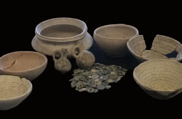 Artifacts seized from the house of an alleged illegal antiquities dealer in Jerusalem, including three magic incantation or swearing bowls. (Yoli Schwartz / Israel Antiquities Authority)