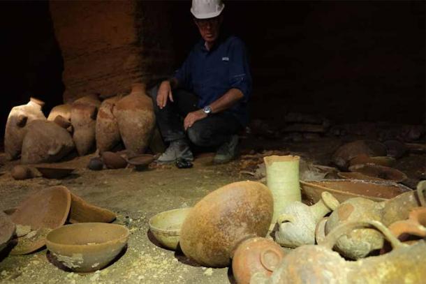 An Israel Antiquities Authority archaeologist surveying artifacts in the Palmahim Ramesses II era tomb not seen by the human eye for nearly 3,300 years. (Emil Algam / Israel Antiquities Authority)
