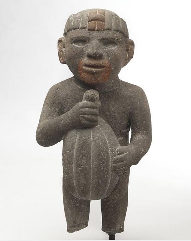 Azteca. Hombre que lleva una mazorca de cacao, 1440-1521. Piedra volcánica, rastros de pigmento rojo.