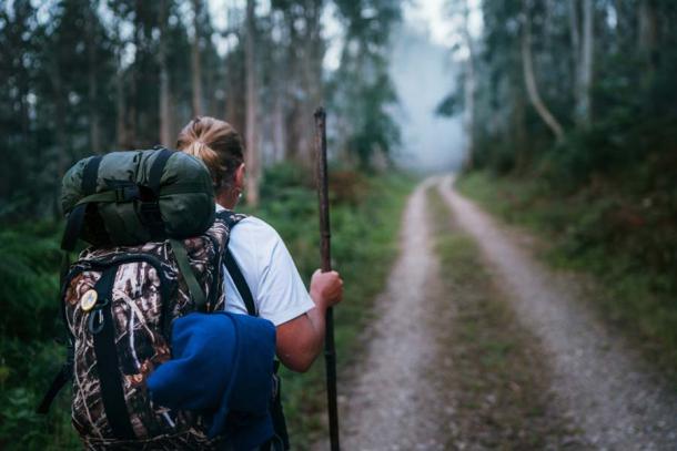 Backpacker walking through eucalyptus forest on the Camino de Santiago in Spain. (Soloviova Liudmyla / Adobe Stock)