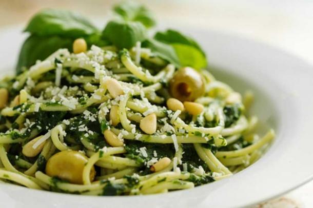 Beautiful Pasta Closeup with Spinach, Cheese, Olives, Basil and Nuts.
