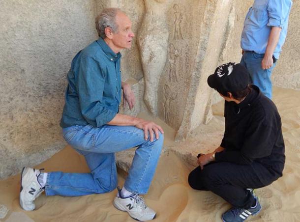 Bob Brier examining carvings in Egypt. Photo credit: Sharon Janet Hague