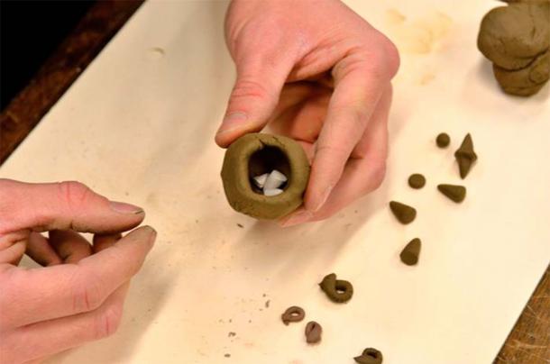 Brian Zimerle, from the Oriental Institute, creating a modern-day clay ball with tokens based on cutting-edge scientific research into the Mesopotamian clay balls. (Oriental Institute of the University of Chicago)