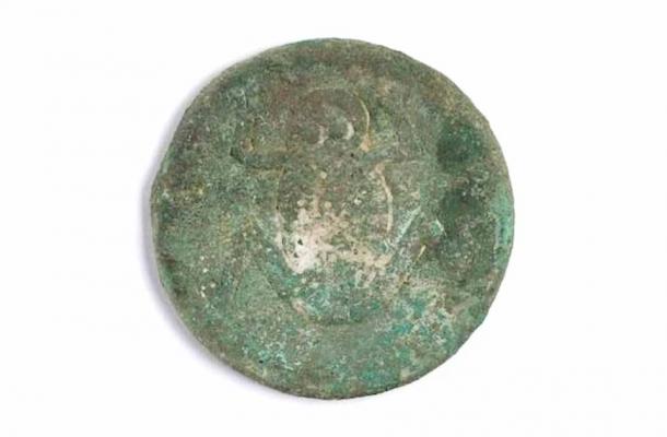 Bronze disc with frog engraving found in the grave. Credit: Kazakh Ministry of Science and Higher Education.