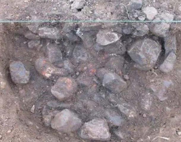 Burnt stones were uncovered in a pit at the center of the henge. 