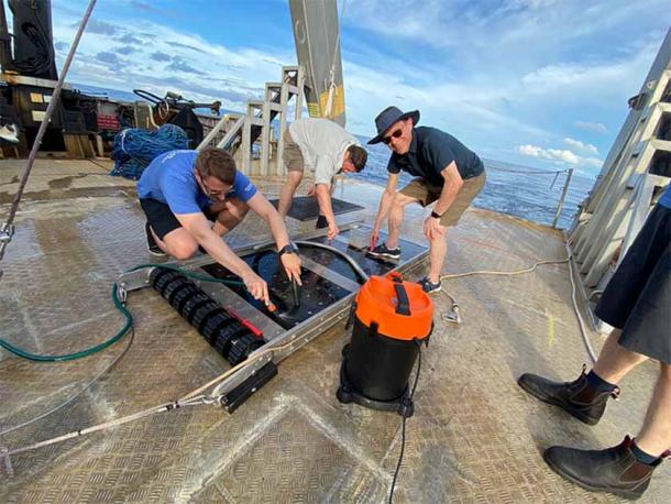 Cleaning and scraping of the sled with magnets that collected the interstellar metal fragments, with team members J.J. Siler (left) and Avi Loeb (right). (Avi Loeb/ Medium)