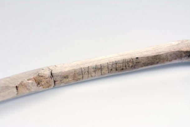 Close-up of a walking stick with a runic inscription, radiocarbon-dated to the 11th century AD. Found in a glaciated mountain pass. (Image: Vegard Vike, Museum of Cultural History)