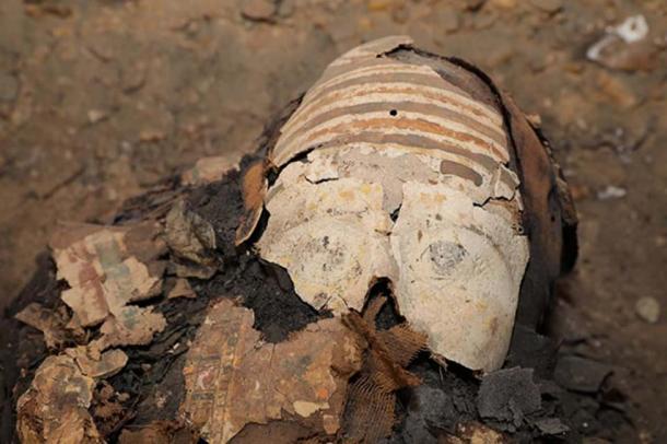 Colored cartonnage over the face of one of the mummies