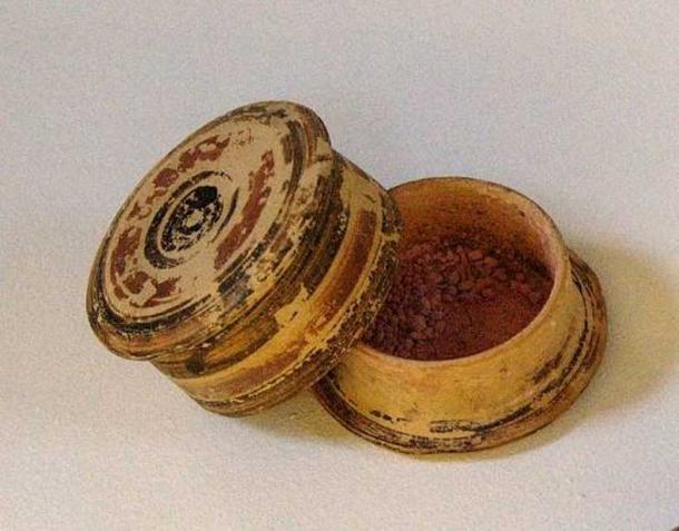 Corinthian pyxis with a red make-up powder. Found in a tomb from the 5th c. BC. 