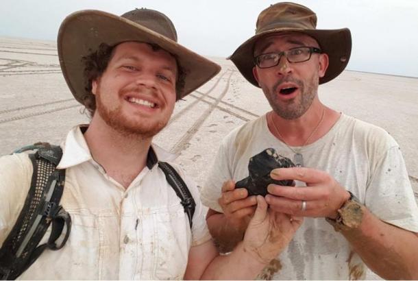 Curtin University researchers Robert Howie and Phil Bland (L to R) show off the 4.5-billion-year-old meteorite.