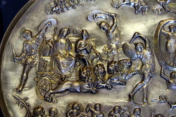 Cybele and Attis (seated right, with Phrygian cap and shepherd's crook) in a chariot drawn by four lions, surrounded by dancing Corybantes (detail from the Parabiago plate.) ( Public Domain )