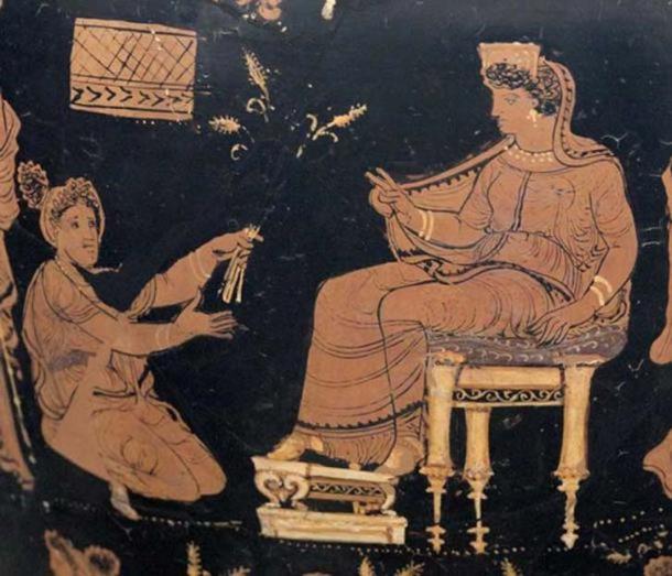 Demeter, enthroned and extending her hand in a benediction toward the kneeling Metaneira who offers the triune wheat that is a recurring symbol of the mysteries 