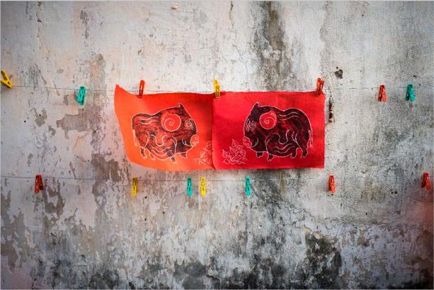 Dong Ho paintings on old aged wall. (Hanoi Photography/Adobe Stock)