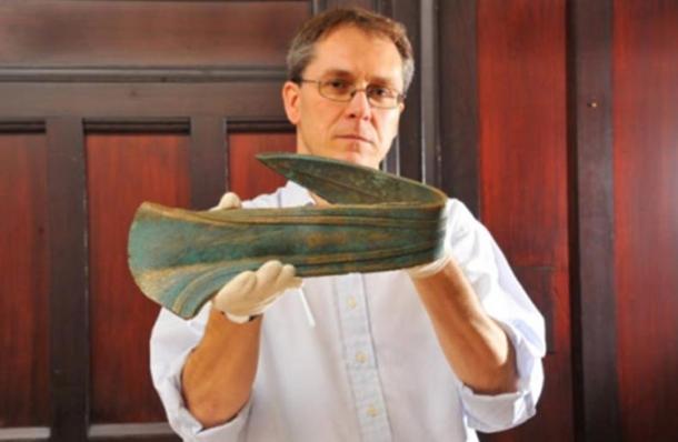 Dr Tim Pestell with the Bronze Age dirk, which was ceremonially bent when it was made. The precious artifact had been used as a door stop.