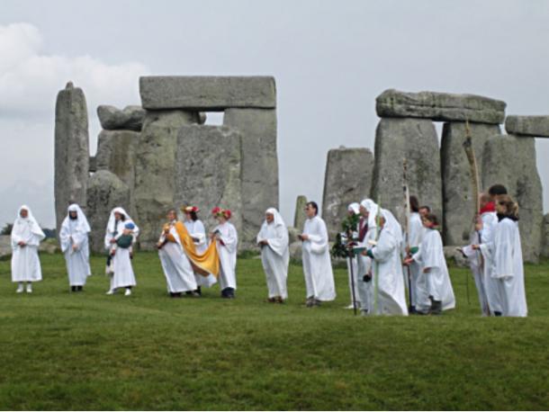 Druids celebrating rituals at Stonehenge.