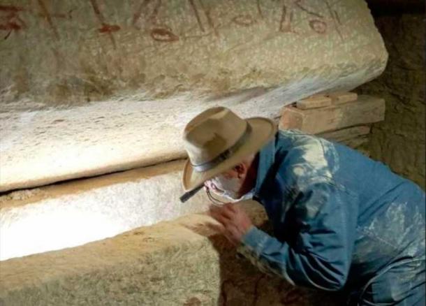 Egyptian archaeologist Zahi Hawass, the director of the Egyptian excavation team, peering into a sarcophagus which was discovered within a shaft at Saqqara in Egypt. (Ali Abu Desheesh)