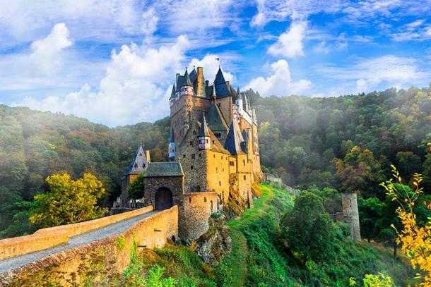 The medieval Eltz Castle, or Burg Eltz, in Germany was first created in the 12th century as part of the formidable Holy Roman Empire. After centuries of warfare it has remained unscathed perched on top of a rock within a small wooded valley. It has even been in the same family for over 800 years! (Freesurf / Adobe Stock)