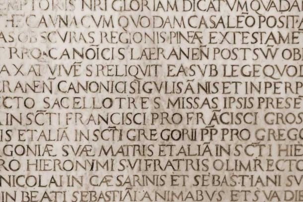 The English language was also heavily influenced by old medieval Latin, especially via Christianity. Shown here is an ancient Catholic Latin inscription. (alehnia / Adobe Stock)