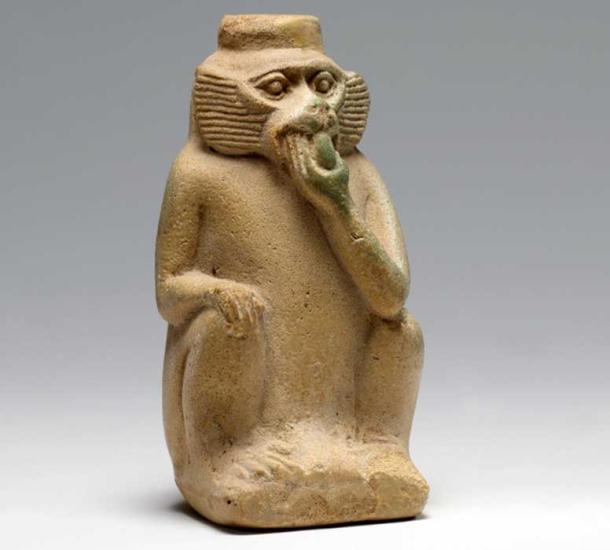 Faience perfume vessel in the shape of a monkey eating fruit. 18th Dynasty. Metropolitan Museum of Art, New York.
