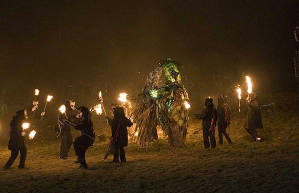 Fire-bearers circle figures of The Green Man fighting Jack Frost 