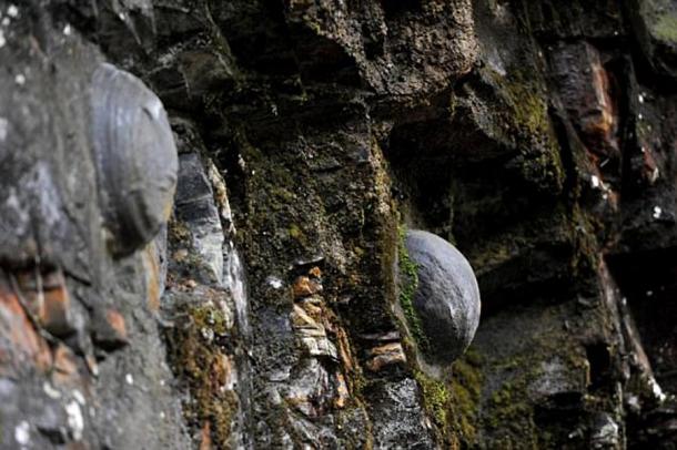 Geologists still don’t completely understand why these stone eggs appear from the Chan Dan Ya cliff in China. (AsiaWire)