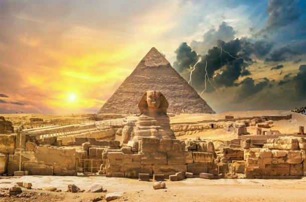 The Great Pyramid of Giza and the Sphinx with a storm in the background. (Givaga / Adobe stock)