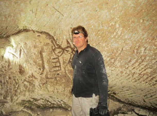 Hiker Ido Meroz near the engravings, including the symbol that has been identified as an ancient key.