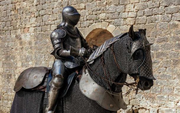 Horse wearing medieval horse armor. (Wirestock / Adobe Stock)