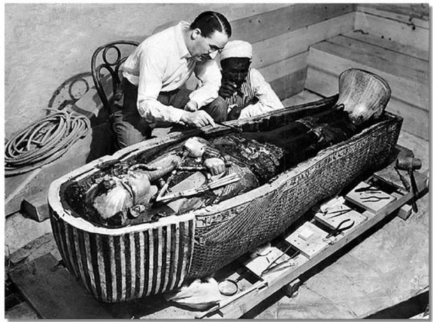 Howard Carter opens the innermost shrine of King Tutankhamun's tomb near Luxor, Egypt which one of Carter's water boys found the steps to.