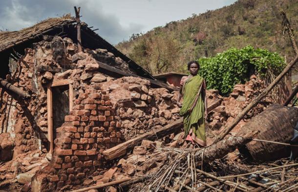 Indian Tribal woman standing near house. (Parij Borgohain / Public Domain)
