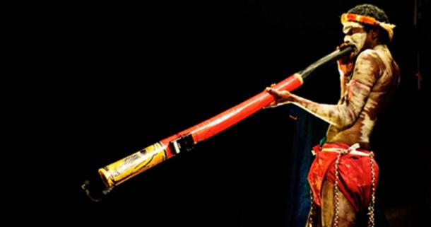 An Indigenous Australian playing the Didgeridoo