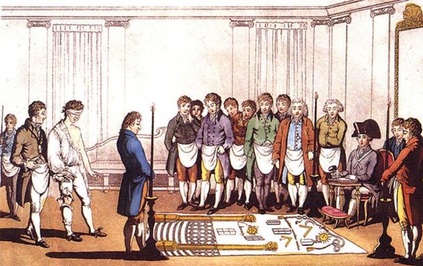 Initiation of an apprentice Freemason around 1800. This engraving is based on that of Gabanon on the same subject dated 1745. The costumes of the participants are changed to the English fashion at the start of the 19th C and the engraving is colored, but otherwise is that of 1745.