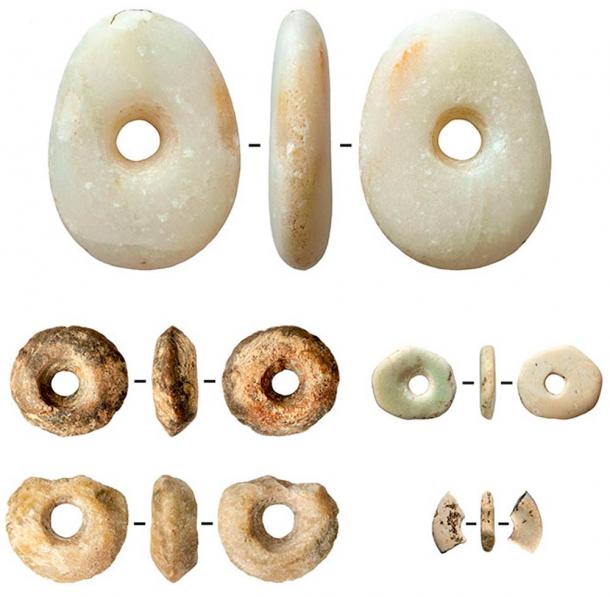 Ivory and talc (soapstone) beads and a marble pebble with traces of ocher.