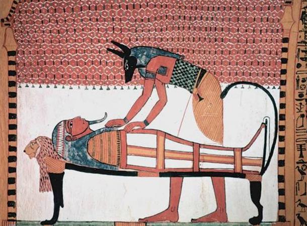 Jackal-headed Anubis attending the mummy of the deceased.