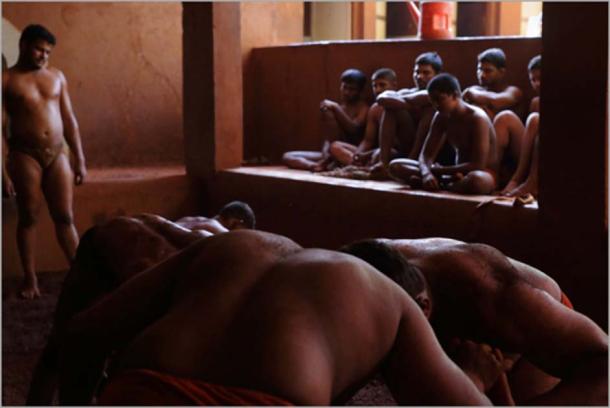 Juniors learning by watching Kushti mud wrestling in Kolhapur, India. (nevil zaveri / CC BY 2.0)