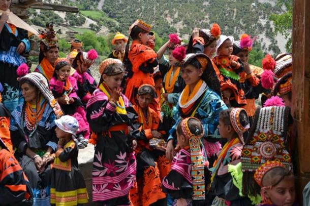 Kalash women and children in traditional bright costume.