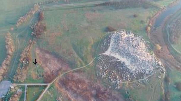 Kamyana Mohyla I (arrow) and the Kamyana Mohyla stone mound, viewed from the south.