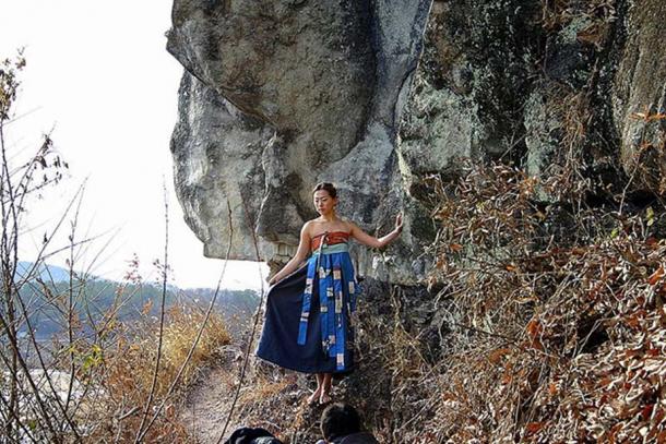 Korean woman posing by a cliff near Andong City where the poem was found.