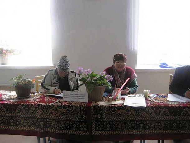 Kyrgyz Election Volunteers in 2010. Some have said the timing of this reburial—on the eve of an October 15 presidential election—indicates the influence of superstitions have had on the country's politics in the past. 