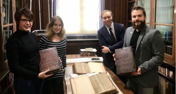 Left to right: Leah Tether, Laura Chuhan Campbell, Michael Richardson, and Benjamin Pohl with the books in Bristol Central Library’s Rare Books Room. The team of experts investigating further if the pieces hold any secret about the legends of Arthur, Merlin, and the Holy Grail. (University of Bristol)