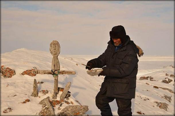 Local Nenets Andrey Vylko repairs the idol. Image: Yamal RGO