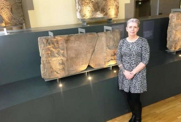 Dr. Louisa Campbell with the Summerston distance stone at The Hunterian Museum. 
