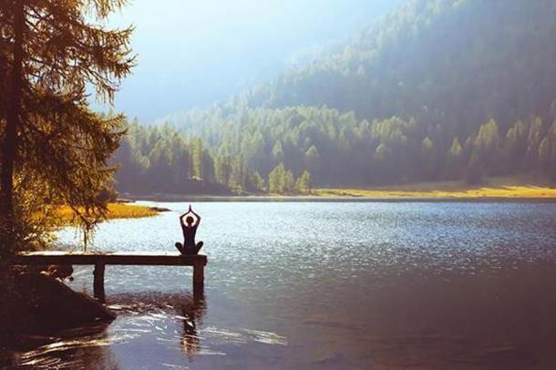 Meditation in nature to attain harmony is a common practice amongst Buddhists, a belief which is rooted in animism. (Song_about_summer / Adobe Stock)