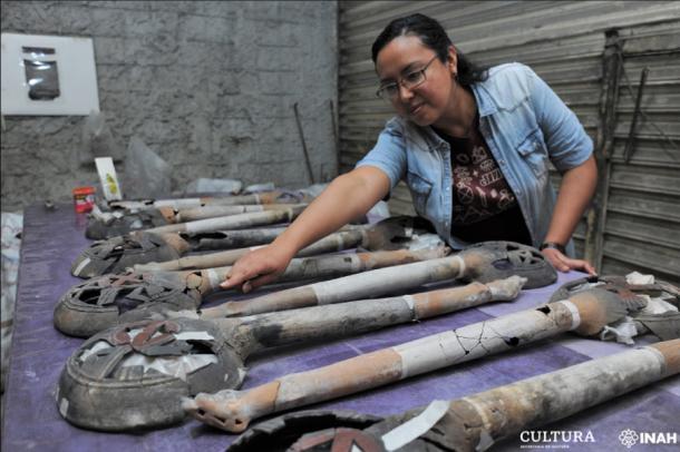 Archaeologist Mara Abigaíl Becerra with religious items found near the Aztec altar found beneath Plaza Garibaldi, Mexico City. (Mauricio Marat / INAH)