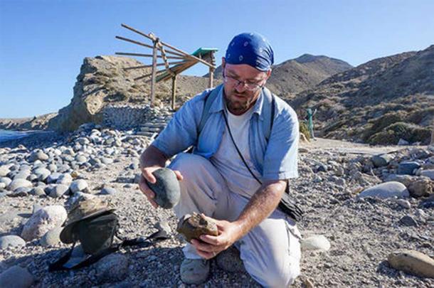 Matthew Des Lauriers turns a beach cobble into a stone tool like one used by people who lived on Cedros Island nearly 13,000 years ago