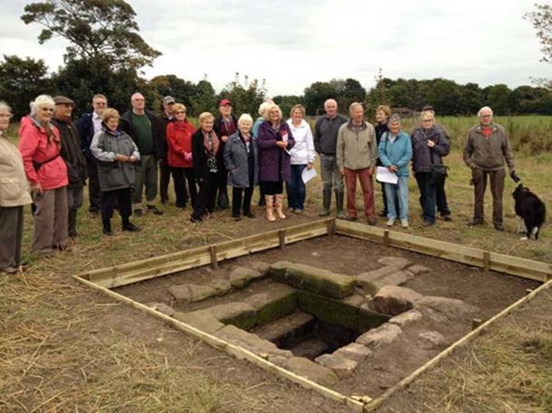 Members of Rainhill Civic Society and Merseyside Archaeological Society with the repaired holy well.