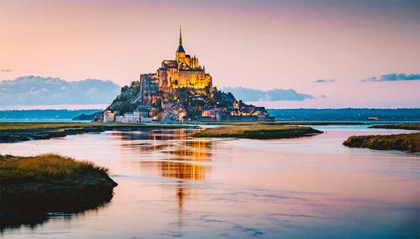The medieval fortress castle and commune of Mont Saint Michel was built on a rocky island off the north coast of France. The town and castle featured in Disney’s Tangled were based on this fairytale castle, which is completely surrounded by water at high tide. (JFL Photography / Adobe Stock)