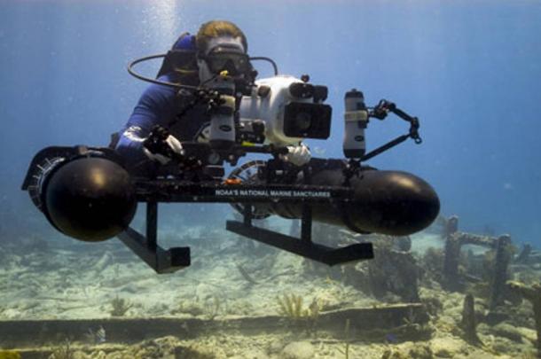 NOAA archaeologist does underwater research using specially a constructed sled mounted with a high-resolution camera.